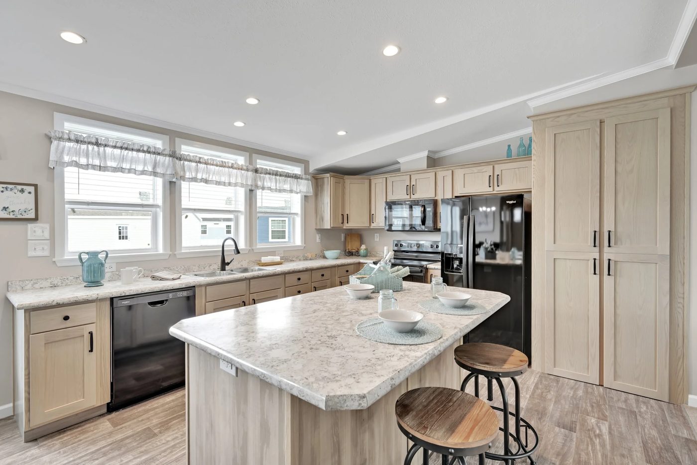 Kitchen with island and light oak cabinets